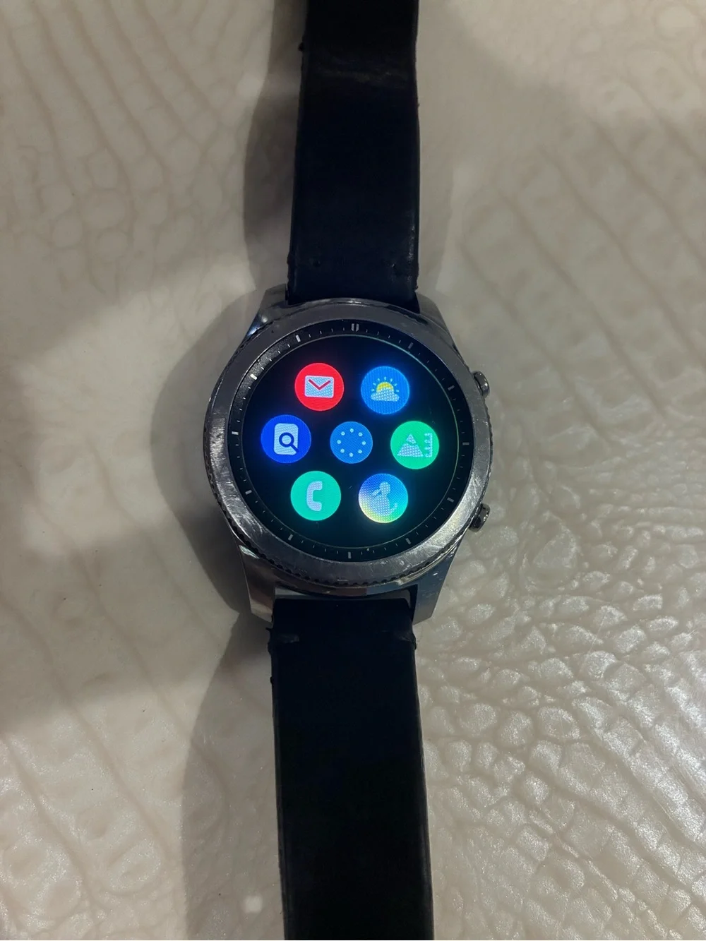 Samsung Silver Smartwatch with Black Strap and Blue Display